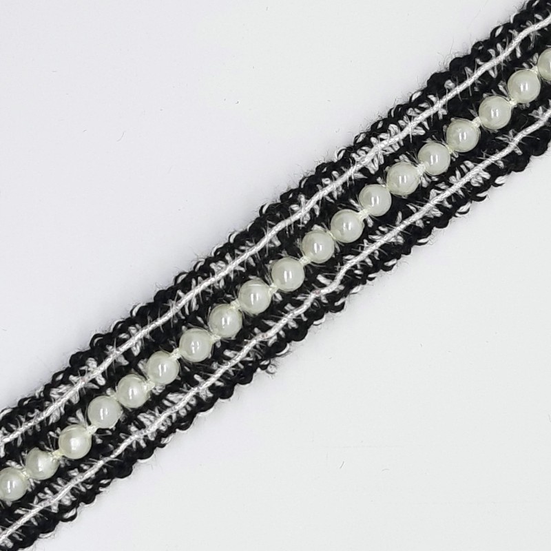 Pasamanería negra con perlas decorativas.