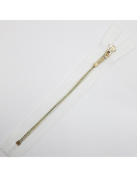 Cremallera metálica blanca malla dorada.